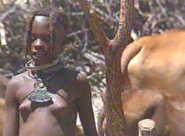 Himba girl looking after the cattle
